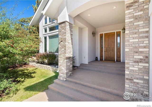 doorway to property with a yard