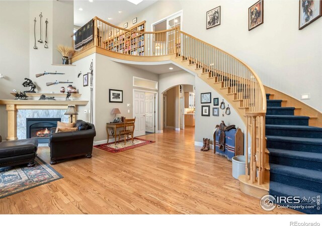 living room with a high ceiling and wood-type flooring