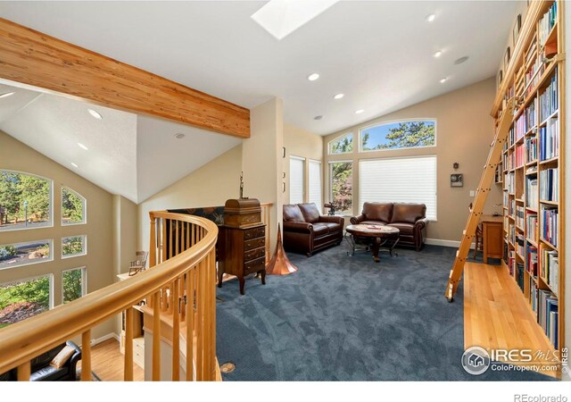 living area featuring carpet floors and vaulted ceiling with skylight