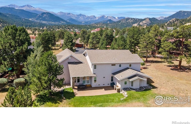 birds eye view of property featuring a mountain view