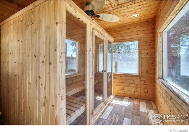 unfurnished sunroom featuring ceiling fan and wood ceiling