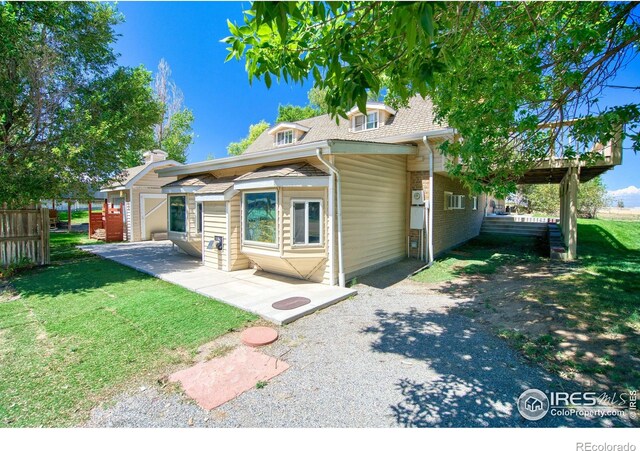 back of house featuring a yard and a patio