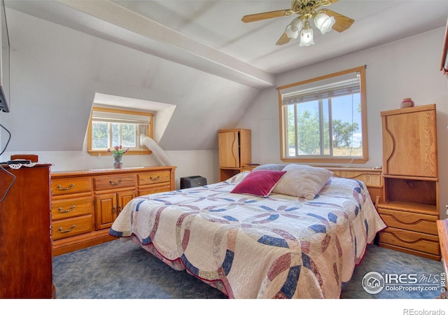 bedroom with multiple windows, lofted ceiling, dark carpet, and ceiling fan