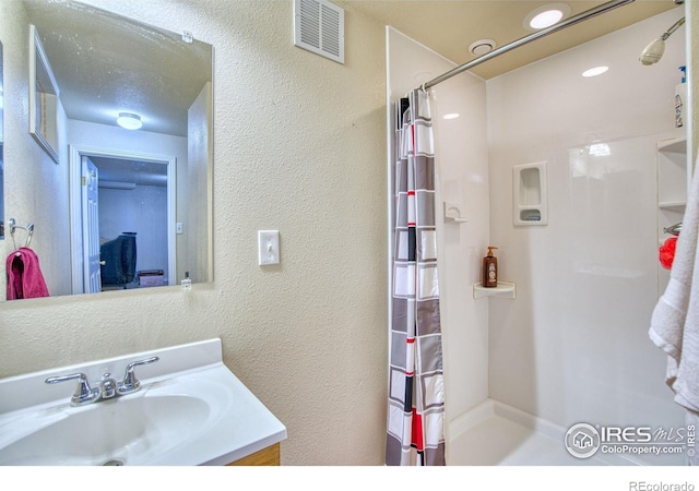 bathroom featuring vanity and a shower with curtain