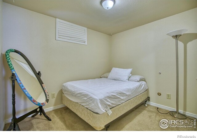 carpeted bedroom with a textured ceiling