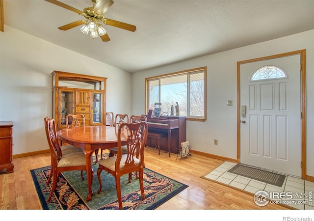 19150 E 195th Ave, Hudson, CO 80642 - dining room with a ceiling fan, baseboards, lofted ceiling, and light wood finished floors
