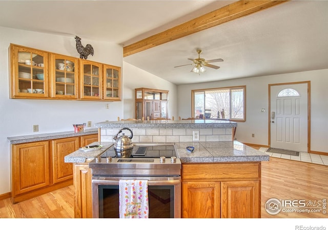 19150 E 195th Ave, Hudson, CO 80642 - kitchen featuring lofted ceiling with beams, tile counters, stainless steel electric stove, and light wood finished floors
