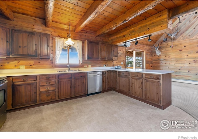 kitchen featuring dishwasher, sink, beamed ceiling, decorative light fixtures, and wooden walls