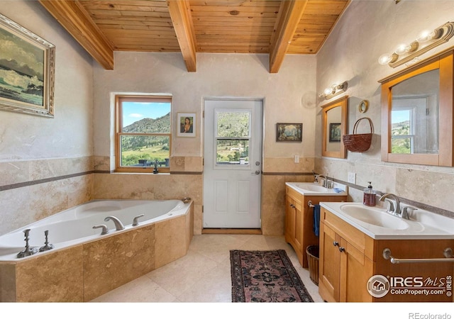 bathroom with tiled bath, double vanity, tile patterned flooring, tile walls, and wood ceiling