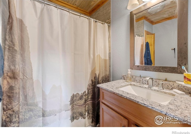 bathroom with wooden ceiling, crown molding, and vanity