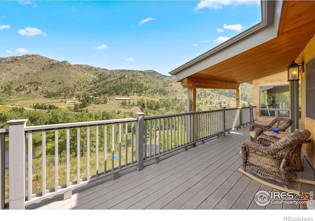 wooden deck with a mountain view