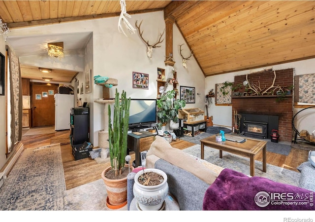 living room featuring a fireplace, high vaulted ceiling, light wood-type flooring, and wood ceiling