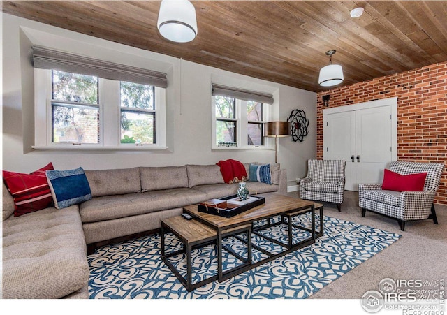 carpeted living room featuring wood ceiling and brick wall