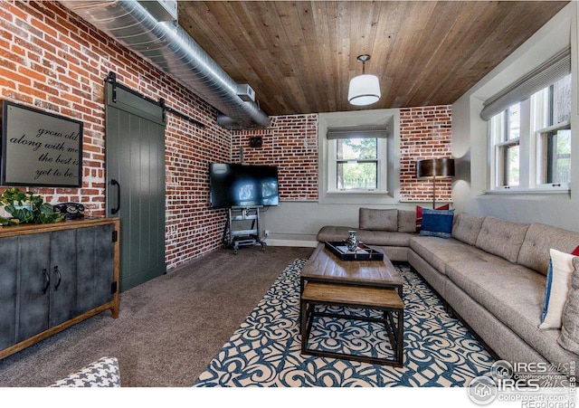 living room featuring wood ceiling, brick wall, a barn door, and plenty of natural light