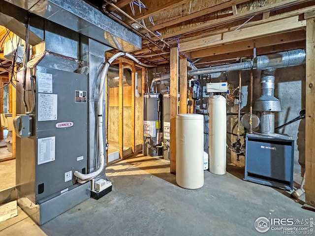 utility room featuring heating unit and gas water heater