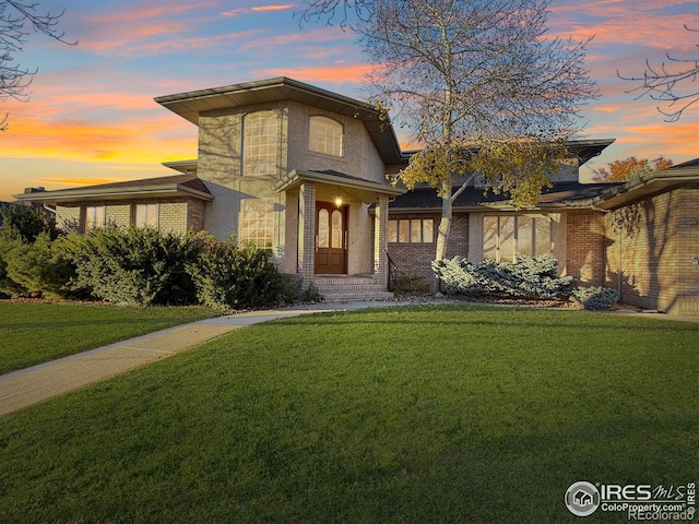 view of front of property with a lawn