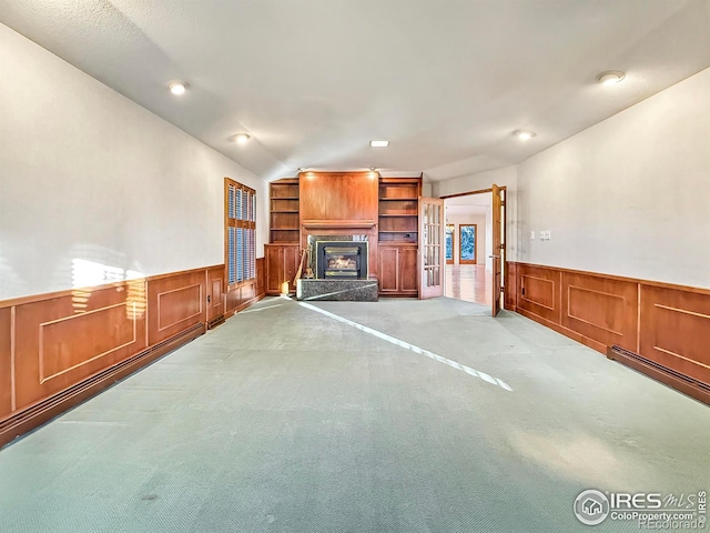 unfurnished living room featuring lofted ceiling and light carpet