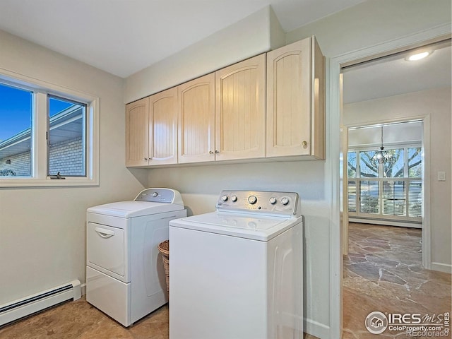 laundry room with washer and clothes dryer, a baseboard radiator, and cabinets