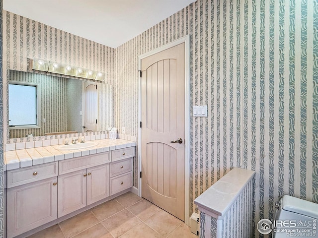 bathroom with tile patterned floors, toilet, and vanity