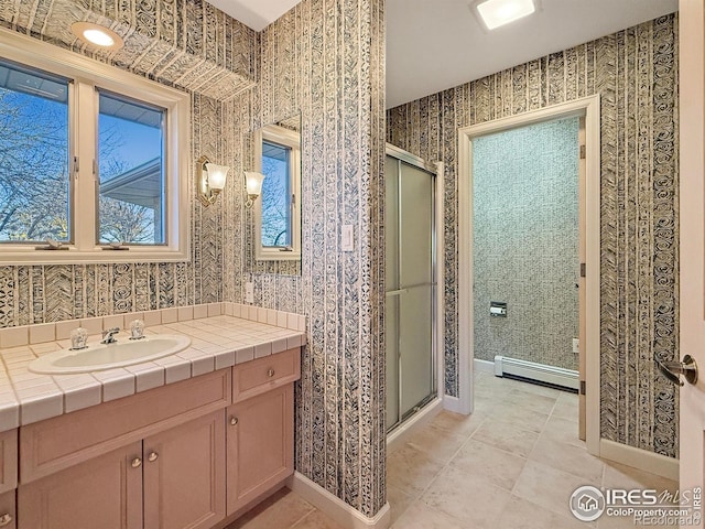 bathroom with tile patterned flooring, a baseboard radiator, vanity, and walk in shower