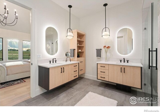 bathroom featuring high vaulted ceiling, hardwood / wood-style floors, and dual bowl vanity