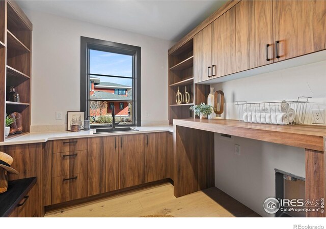 kitchen featuring light wood-type flooring and sink