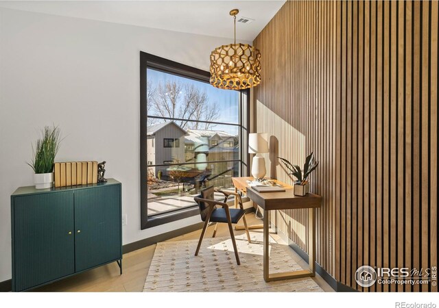 home office with light hardwood / wood-style flooring