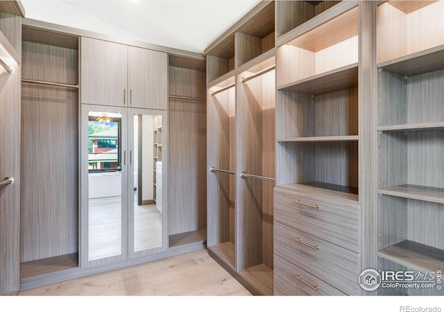 walk in closet featuring light hardwood / wood-style flooring