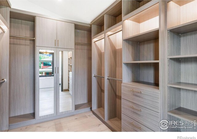 walk in closet featuring light hardwood / wood-style flooring