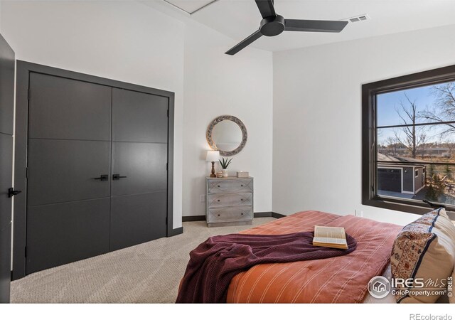 carpeted bedroom featuring a closet and ceiling fan