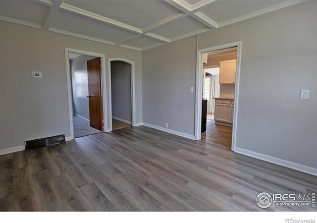 unfurnished room with hardwood / wood-style floors, coffered ceiling, and beamed ceiling