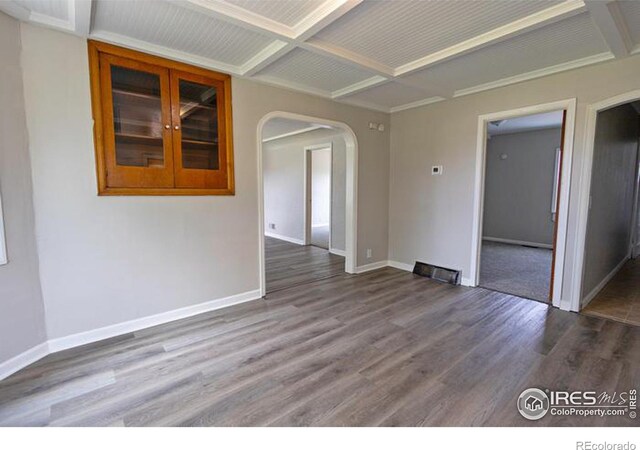 unfurnished room featuring coffered ceiling and dark hardwood / wood-style floors