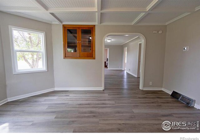 unfurnished room with beam ceiling, wood-type flooring, and coffered ceiling