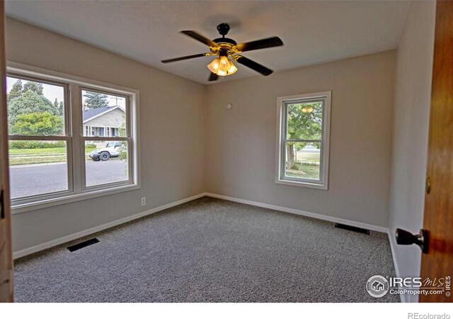 carpeted empty room featuring ceiling fan