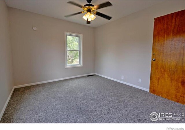 empty room with ceiling fan and carpet floors