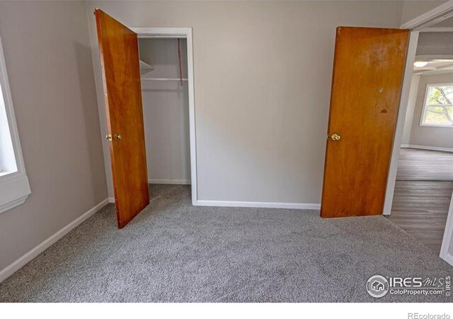 unfurnished bedroom featuring a closet and carpet floors