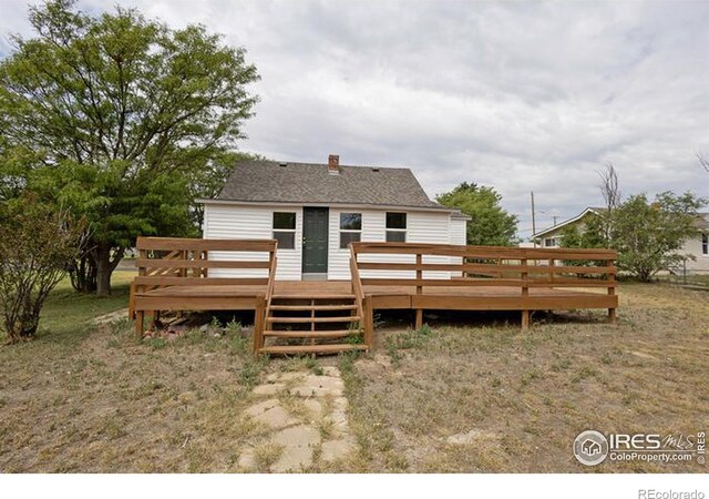 rear view of property featuring a deck