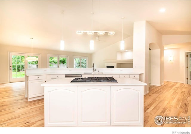 kitchen featuring light countertops, appliances with stainless steel finishes, a sink, and white cabinetry