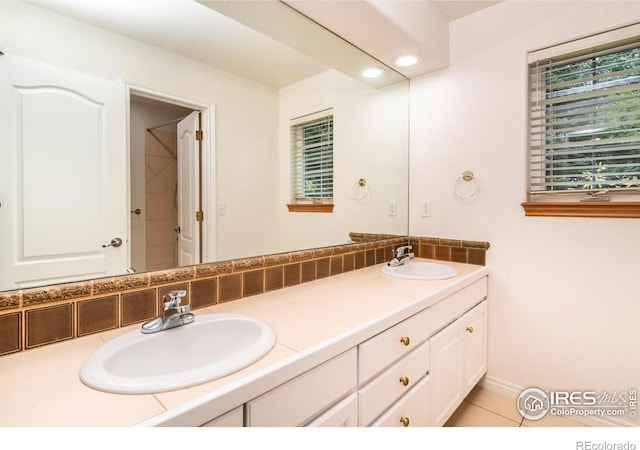 full bathroom featuring double vanity, a sink, and recessed lighting