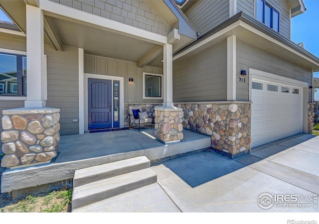 property entrance with a garage and covered porch