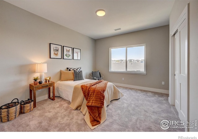 carpeted bedroom featuring a closet