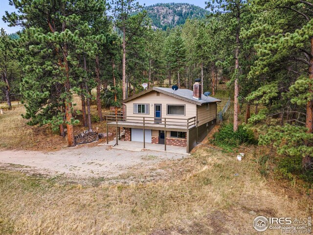 exterior space with a garage and a wooden deck