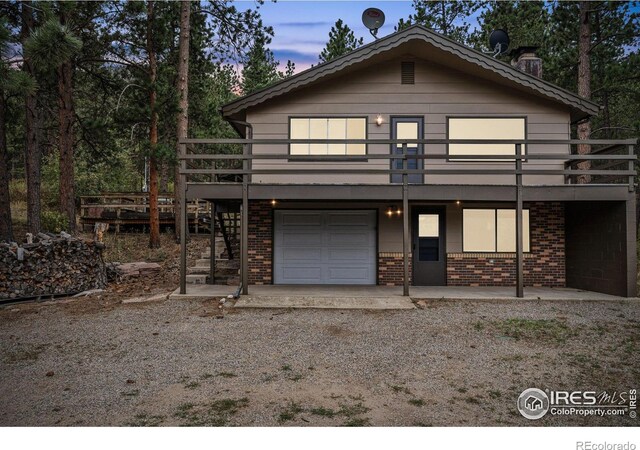 view of front facade with a deck and a garage