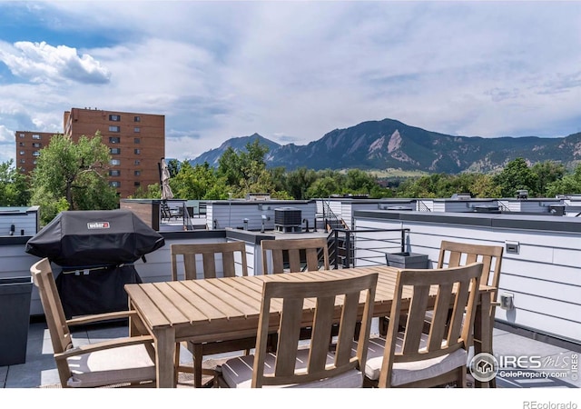 exterior space with a balcony, a mountain view, and grilling area