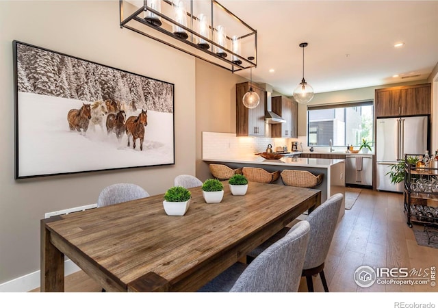 dining room featuring wood-type flooring and recessed lighting