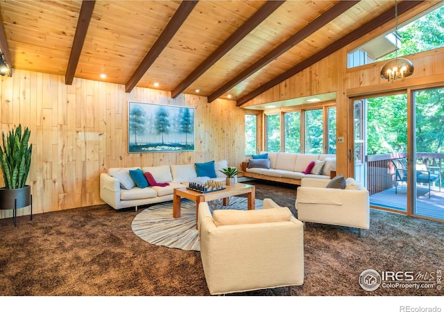 living room featuring a notable chandelier, lofted ceiling with beams, carpet flooring, wood walls, and wooden ceiling