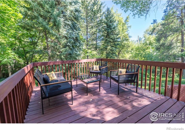 wooden terrace featuring an outdoor hangout area