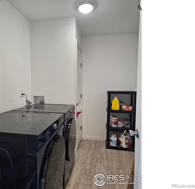 washroom featuring light hardwood / wood-style flooring and washing machine and dryer