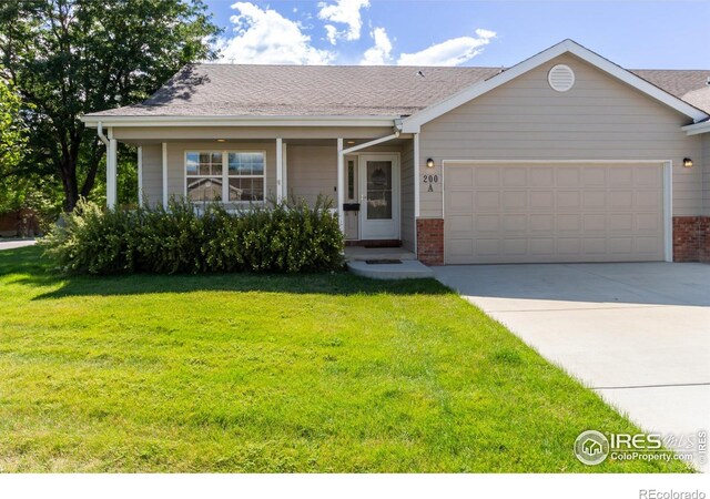 view of front of home with a garage and a front lawn