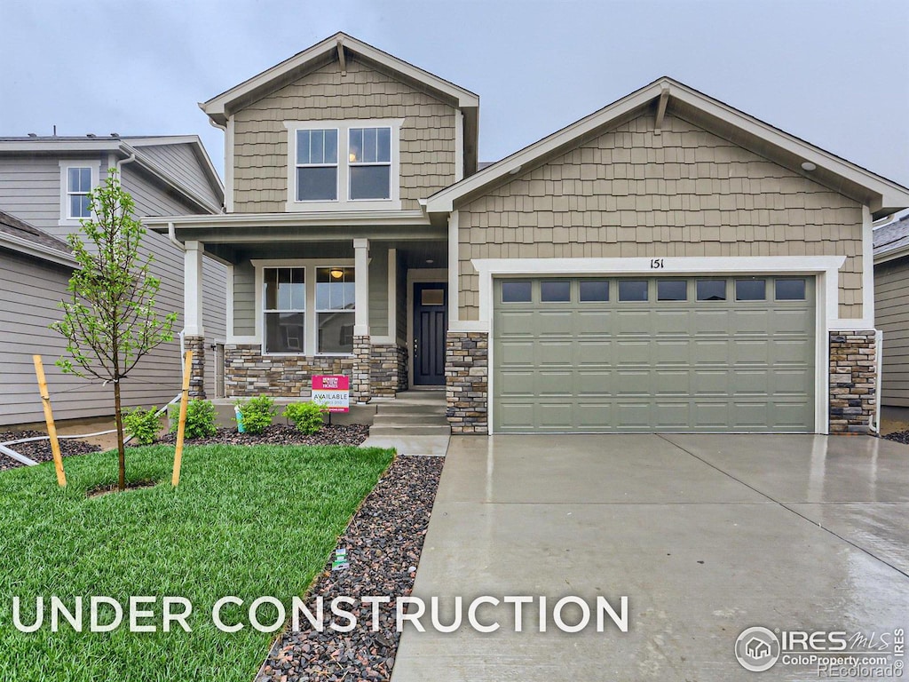 craftsman inspired home featuring a garage and a porch